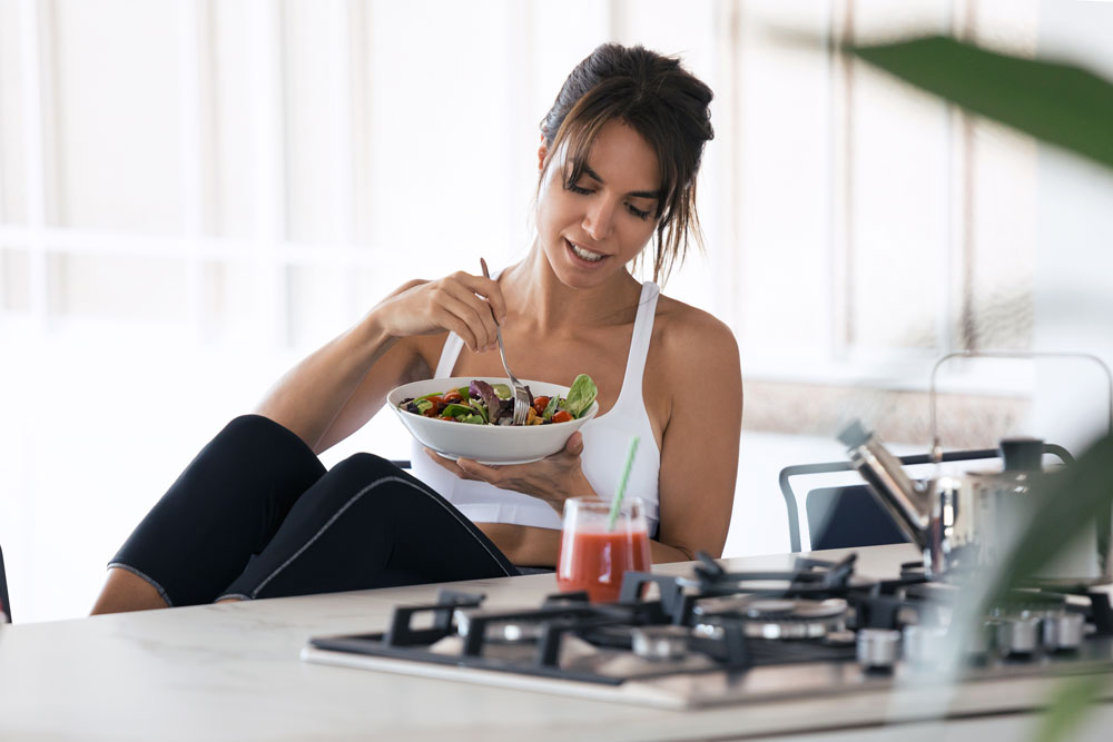 Woman eating salad.